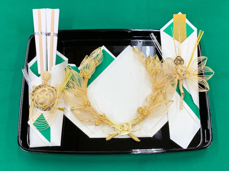 花嫁、花婿の結納に使用する漆を3色使い完成した日本酒と一緒に納める